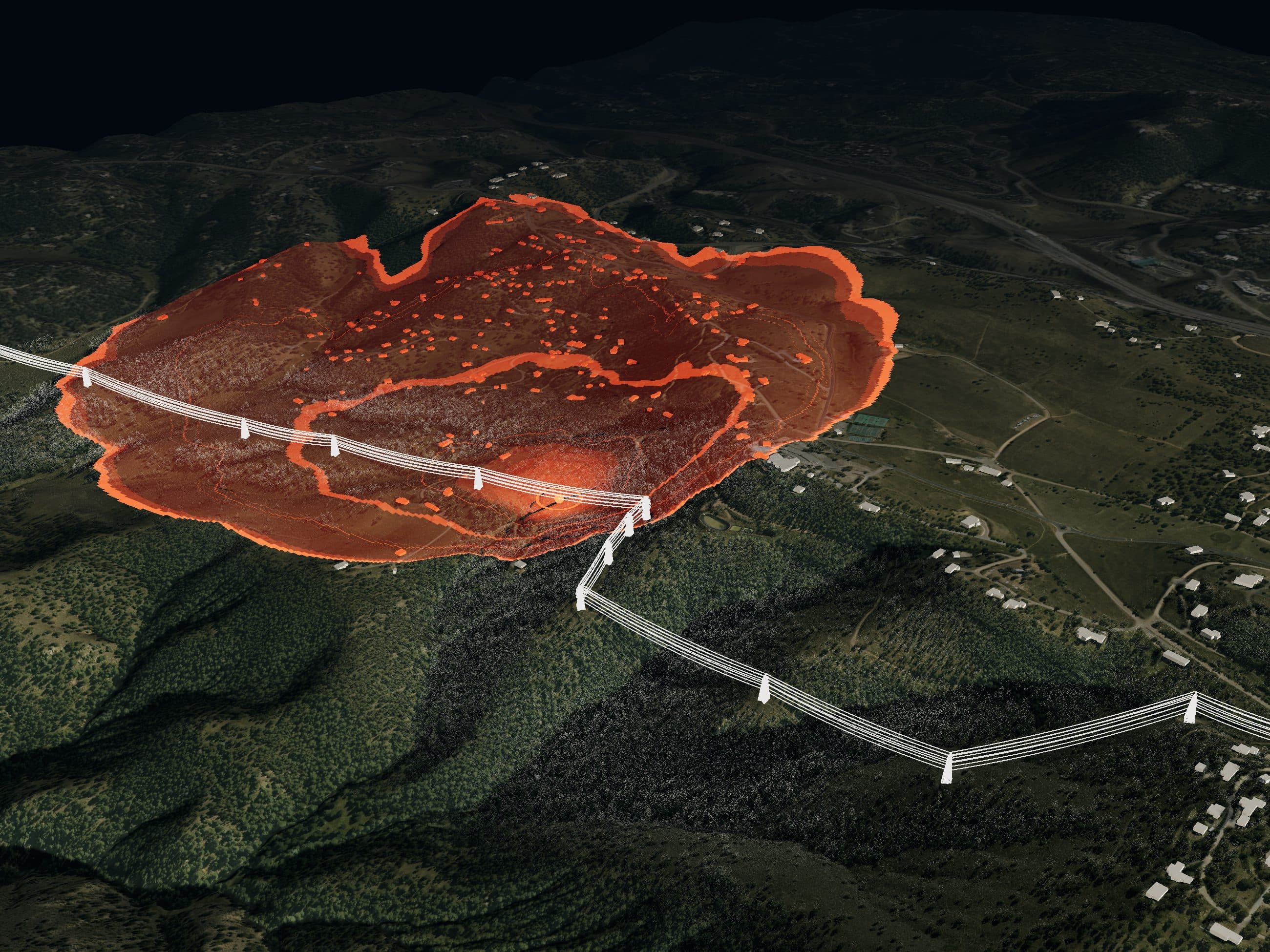 Rendered oblique view of a transmission line crossing a forested canyon, with a simulated fire spreading from an ignition on the line toward homes on the far slope.