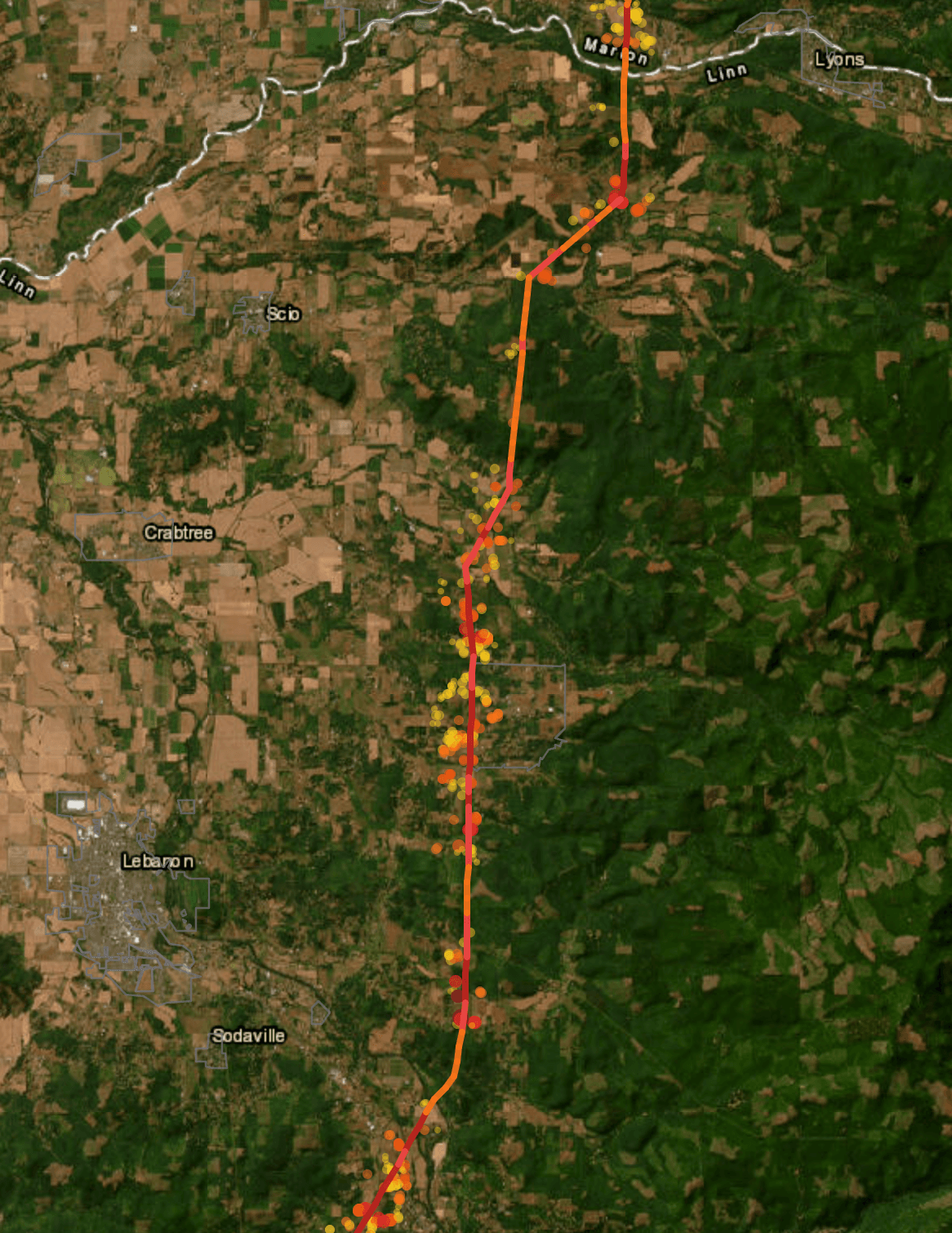 A transmission corridor on satellite imagery, coloured by segment risk, with modeled structure exposure clustered along the line.